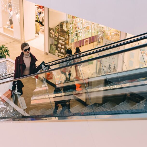 woman riding escalator